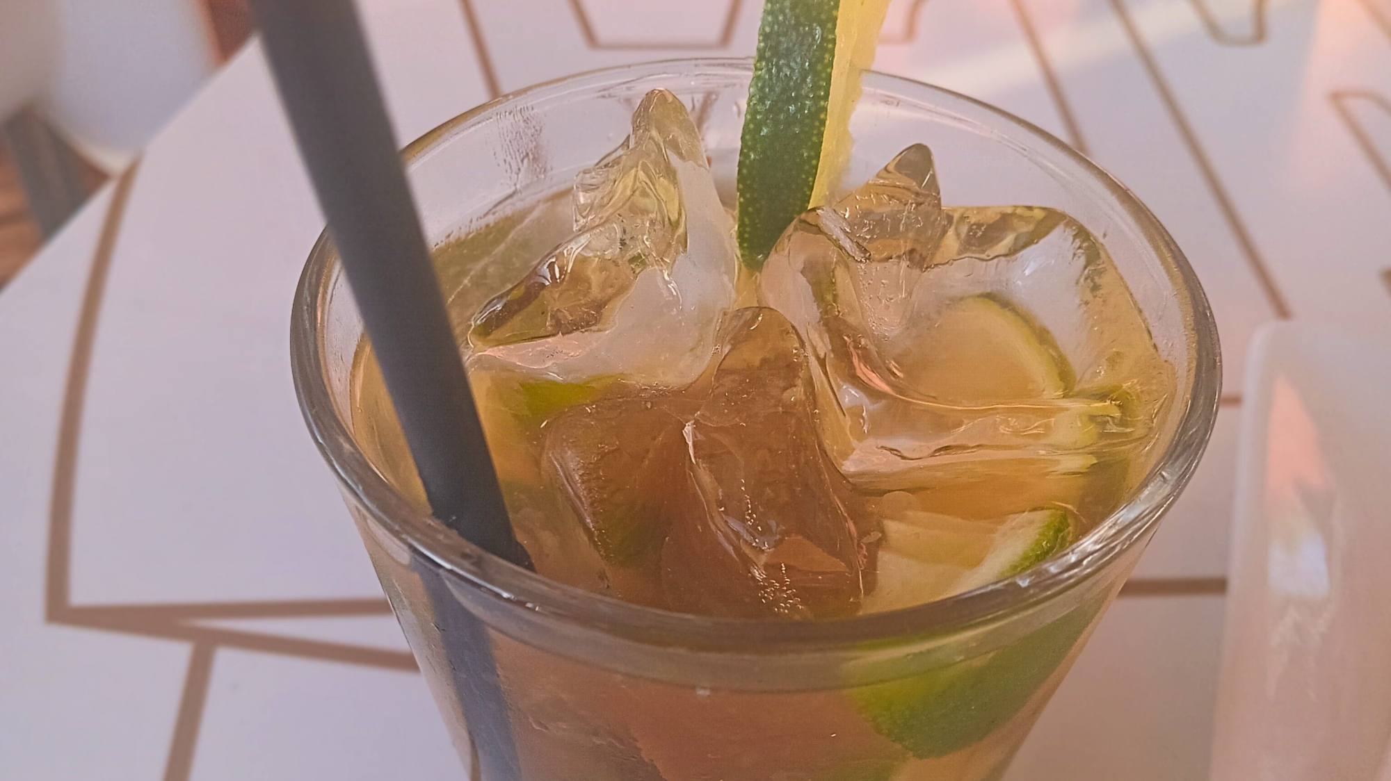 A drink with ice on a café table