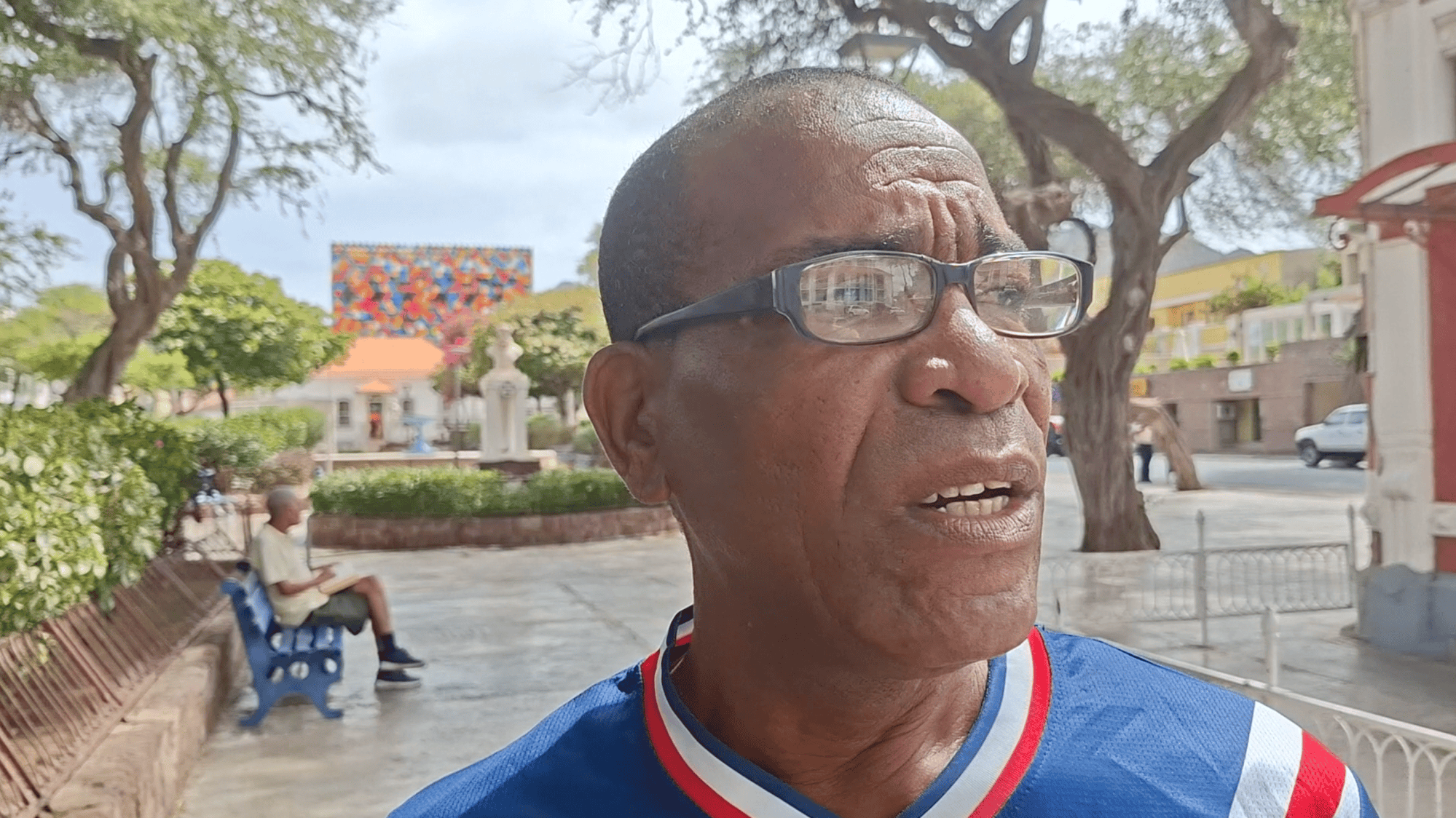 A man in a blue football shirt on a square in Mindelo